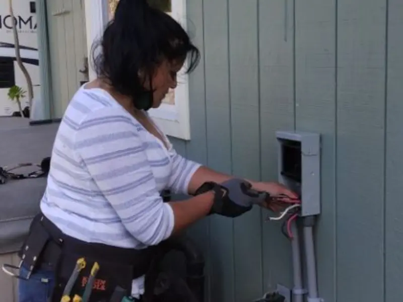 Licensed electrician wiring an exterior subpanel in Cambridge